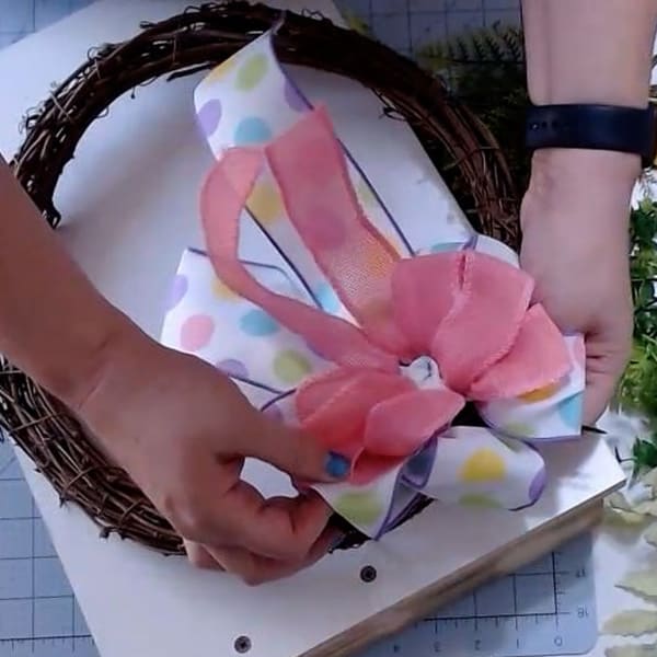 Add a bow to wreath