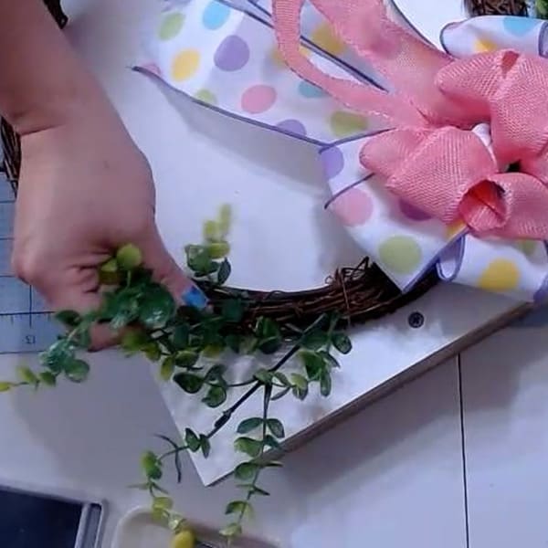 Insert greenery into wreath