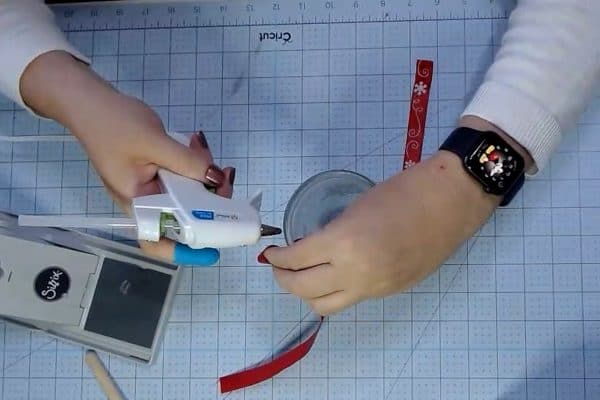 Using glue gun to attach ribbon to mason jar rim - alifeofbalance.com