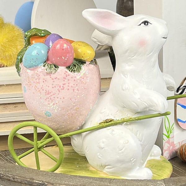 Easter bunny with egg shaped wheelbarrow figurine