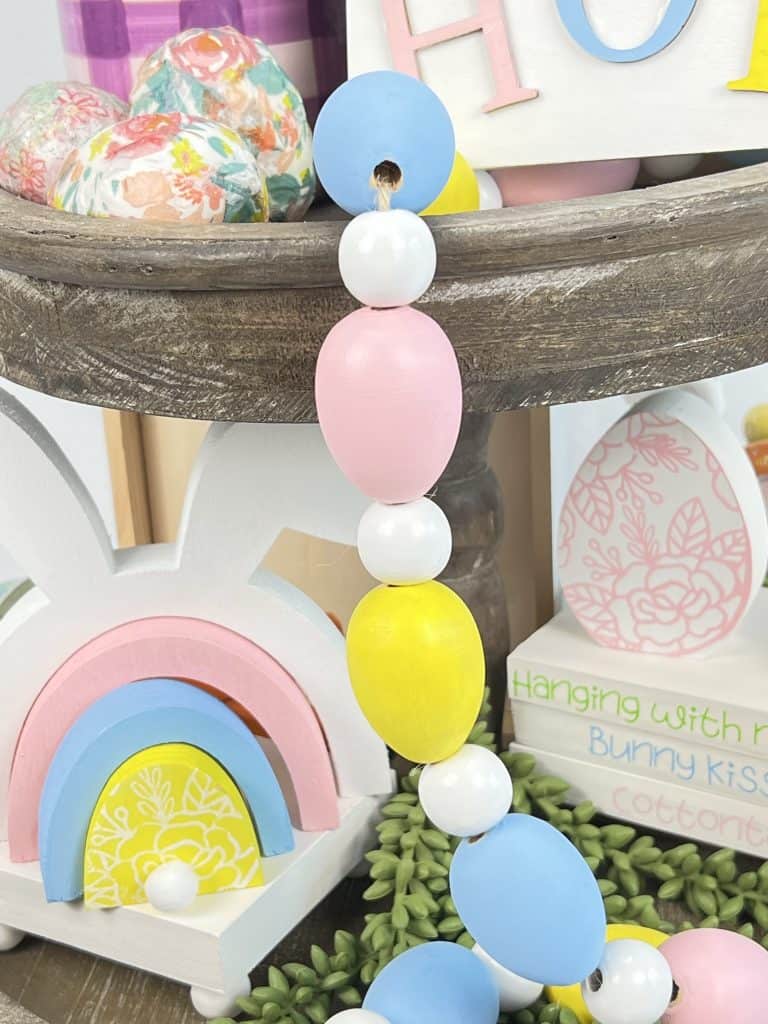 Wooden egg garland on Easter tiered tray.