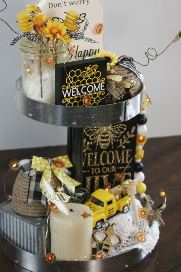 Sunflower lights being used for to link the tiers in a bee themed tiered tray.