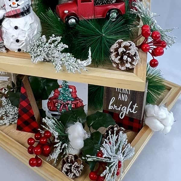 Christmas greenery on a styled tiered tray.